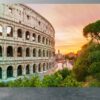 Colosseum illuminated by sunrise amidst greenery on vinyl mural